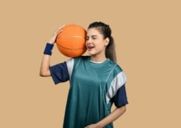 a girl holding a basketball