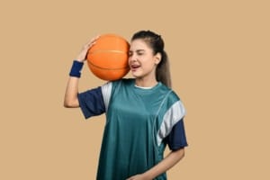 a girl holding a basketball