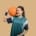 a girl holding a basketball
