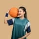 a girl holding a basketball