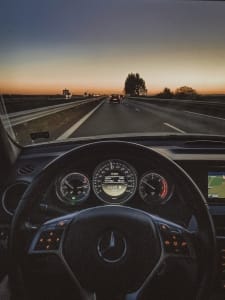 a car driving down a highway at sunset