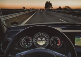 a car driving down a highway at sunset