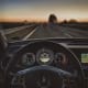 a car driving down a highway at sunset