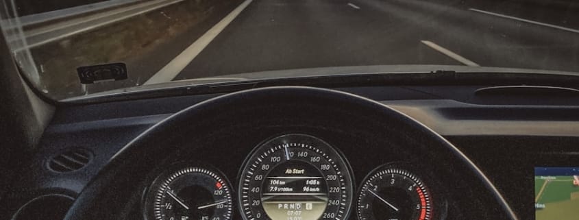 a car driving down a highway at sunset
