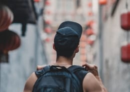 man holding black backpack