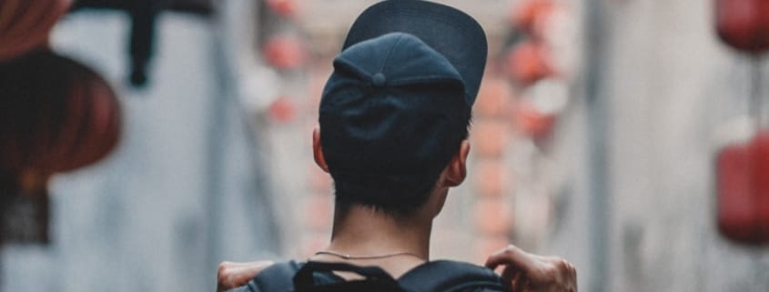 man holding black backpack